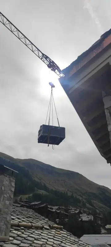 Grutage d'un spa au-dessus d'une toiture en ardoise